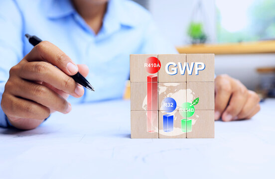 Global warming potential GWP concept with businessman compare value of each refrigerant on wooden block for cooling system and air conditioner use and decision for environment save