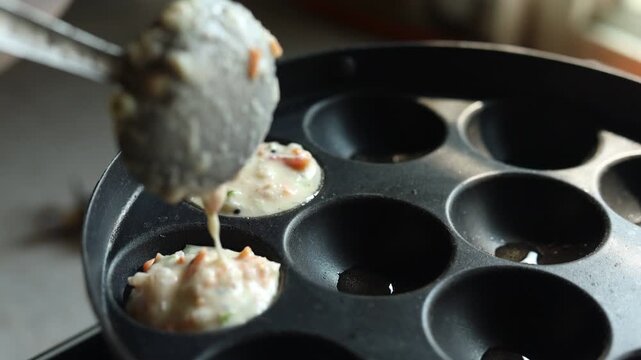 Appam or Mixed dal or Rava Appe South Indian dish preparation on iron pan