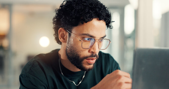 Coding, laptop and thinking with man in office at night for problem solving or solution. Business, computer and web design with programmer in workplace for evening maintenance or troubleshooting