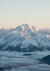 Obraz premium Breathtaking view of a snow-dusted mountain range, softly illuminated by warm morning light over clouds