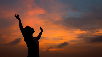 Silhouette of prayer woman worship God in the morning with sunrise sky background Person hands open palm up worship God helping repent catholic easter lent mind pray Christian religion 