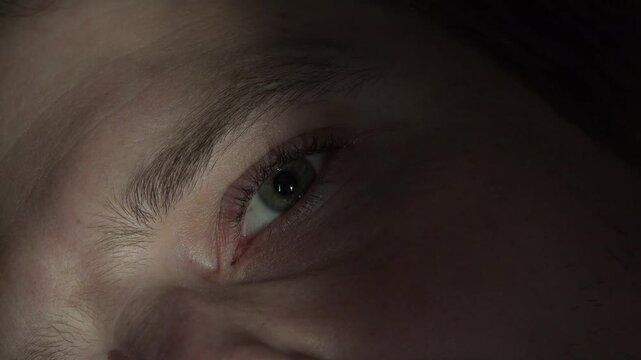 Eye of male laying in bed with sun on face 4k