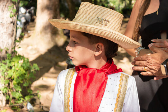 Portrait of a Latino boy wearing a traditional costume with a  shirt and hat, ready to dance the popular Sanjuanero Huilense in Neiva, Huila, Colombia. Concept of childhood and Colombian culture