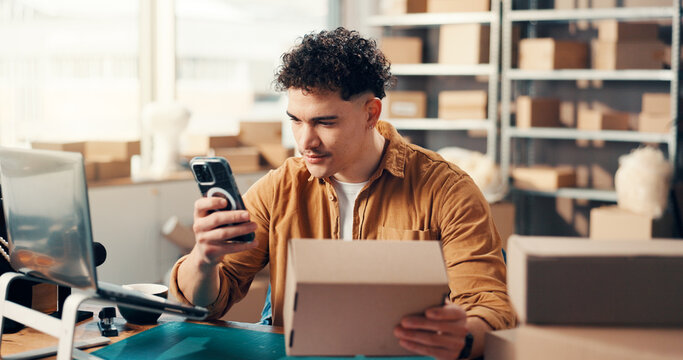 Box, phone and supply chain with man in distribution office for barcode scanning or parcel tracking. Inventory, logistics and photograph with employee at desk for delivery, ecommerce or shipping - Powered by Adobe