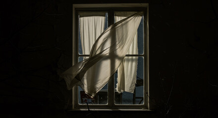 The wind from the window flutters the curtains in the old house in the moonlight.