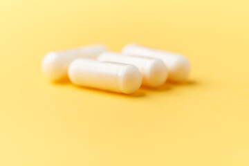 Creatine capsules on paper background. Soft focus. Close up. Copy space.	