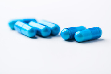 Amino acids capsules on bright background. Soft focus. Close up. Copy space.	