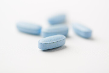 Multivitamin tablets on bright paper background. Close up. Copy space	