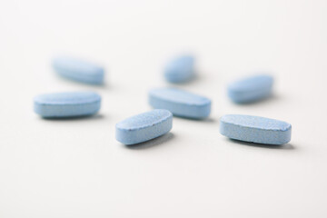 Multivitamin tablets on bright paper background. Close up. Copy space	