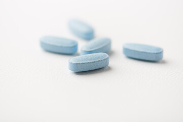 Multivitamin tablets on bright paper background. Close up. Copy space	