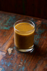 Mango smoothie on wooden background. Soft focus. Copy space.	