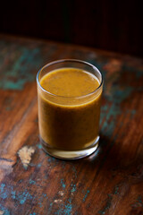 Mango smoothie on wooden background. Soft focus. Copy space.	