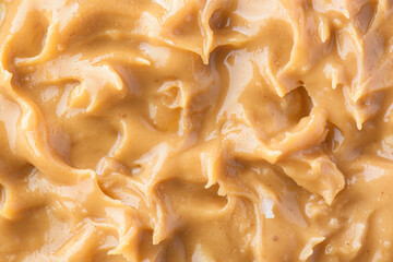 Closeup view of tasty peanut butter. Sweet organic eco food