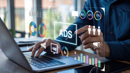 Digital marketing expert analyzing advertising campaign data on laptop with modern interface