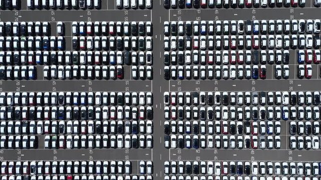 High aerial drone footage of car export and customs terminal with lined vehicles and logistics operations in Grimsby England UK