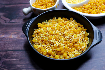 A close up of traditional Indian snacks. crispy savory sev and sweet golden boondi served together. Perfect flavors in authentic Indian namkeen and festive treats. sev bundi.