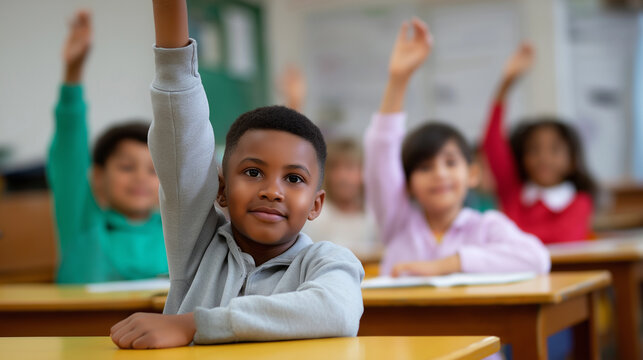 Children raising hands in classroom during lesson. 
