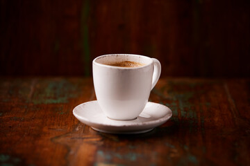 Cup of coffee on wooden background. Soft focus. Copy space	