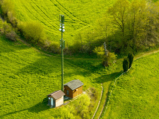 Aerial view of mobile phone antenna tower in rural area in Switzerland. Antenna in Sense district near Fribourg.
