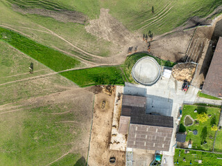Aerial view of farm house in Switzerland in Canton of Fribourg. Rural fields in evening sunlight.