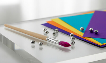 Modern Art Supplies Still Life: Paintbrush, Watercolor Paper, and Beads