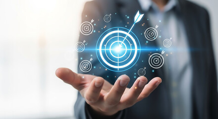 Fototapeta premium Businessman holding a glowing target with an arrow hitting the bullseye, symbolizing business goals, success, and strategic achievement in a bright, modern environment