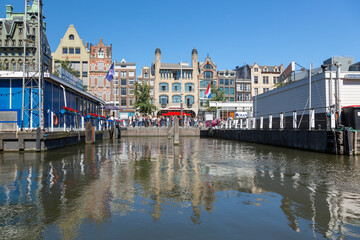 Amsterdam, Netherlands - July 02, 2018: View of the mooring of pleasure boats on Damrak Street in Amsterdam