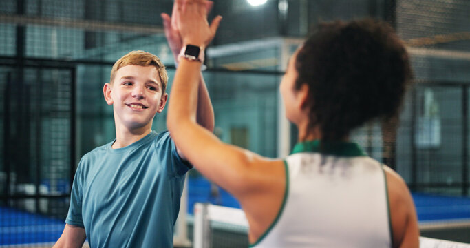 Happy boy, teenager and high five with coach for padel tennis match, winning or indoor sport. Junior player, trainer and touch with smile in court for good job, well done or finish together at club