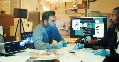 Man, teamwork and investigation with fingerprints screen for crime scene, evidence or trace of...