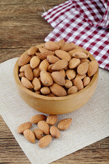 Fresh almonds in wooden bowl.close up