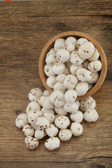 Fresh fox nuts or lotus seeds in wooden bowl
