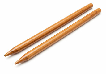Two wooden knitting needles with tapered points showing wood grain detail