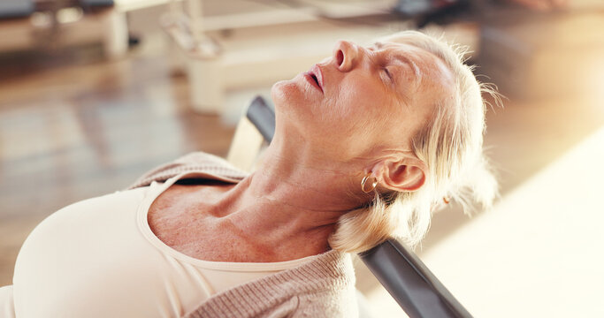 Break, pilates and reformer with mature woman in studio for exhaustion, fatigue or recovery. Exercise, fitness and rest with tired old person in health class for training, wellness or workout - Powered by Adobe