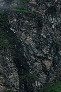 man climbing a via ferrata at Moiry Dam Switzerland