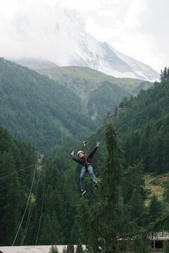 boy doing a zip wire in the mountains in Zermatt Switzerland