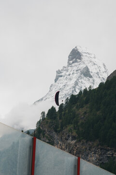 person paragliding next to the Matterhorn mountain in Switzerland