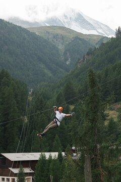 man doing a zip wire in the mountains in Zermatt Switzerland