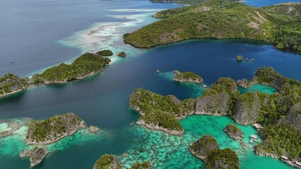 defaultAerial view of Piaynemo islands in Raja Ampat, Indonesia, with turquoise lagoons, lush green...