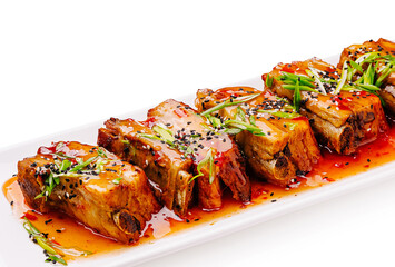 Deliciously presented pork belly drizzled with spicy sauce and garnishes