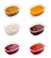 Variety of colorful sauces in plastic containers for culinary use