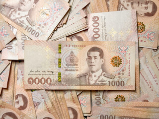 Close view of 1000 Thai baht banknotes stacked together, symbolizing financial stability, secure wealth building, successful trading strategies and the long-term prosperity of family investments.