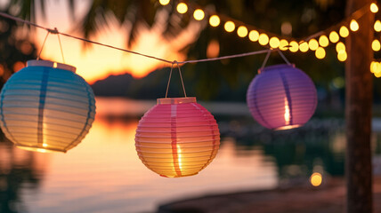 Fototapeta premium Vibrant paper lanterns glow warmly at sunset creating a magical party atmosphere by the water