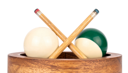 Two crossed pool cues and two billiard balls isolated on solid white background