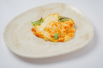 Indulge in a delightful baked cheese creation adorned with fresh herbs, perfect for sharing
