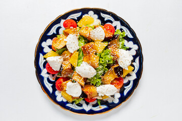 A colorful dish showcases a delightful assortment of greens, tomatoes, and cheese, inviting taste