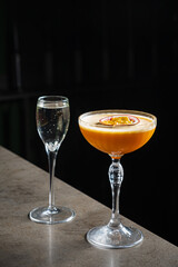 Two beautifully crafted cocktails await enjoyment, showcasing vibrant colors and intricate designs