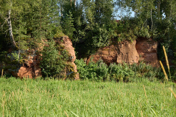 A Serene Landscape Featuring a Beautiful Rock Formation Surrounded by Lush Greenery and Nature