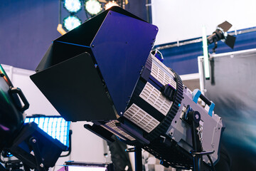Fototapeta premium Professional studio LED close-up spotlight. Modern equipment for film, television and photo studios. Metal case with cooling, the front part is equipped with light-forming elements.