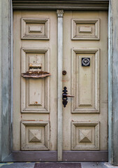 Old wooden entrance door of a historic town building, showcasing the charm of ancient architecture in the old city.