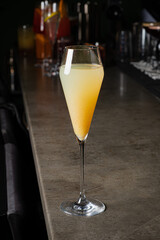 Bright and vibrant citrus drink awaits as patrons enjoy the atmosphere at a stylish bar